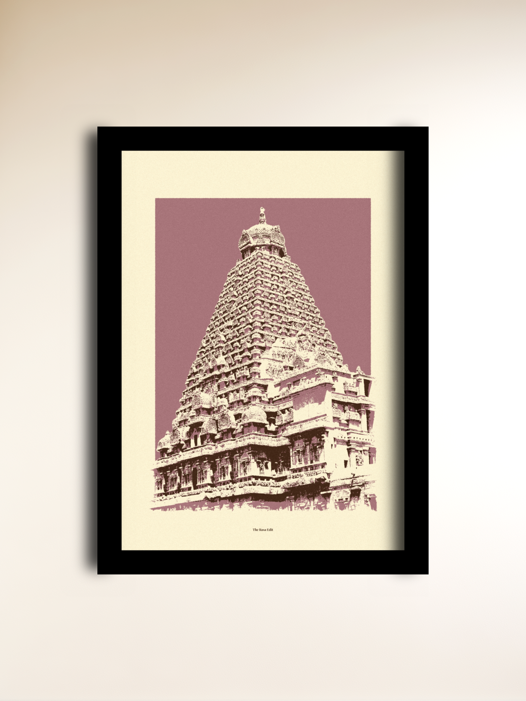 A framed art print featuring a sepia-toned illustration of Brihadeeswara Temple against a dusty mauve background, mounted on a light beige wall.